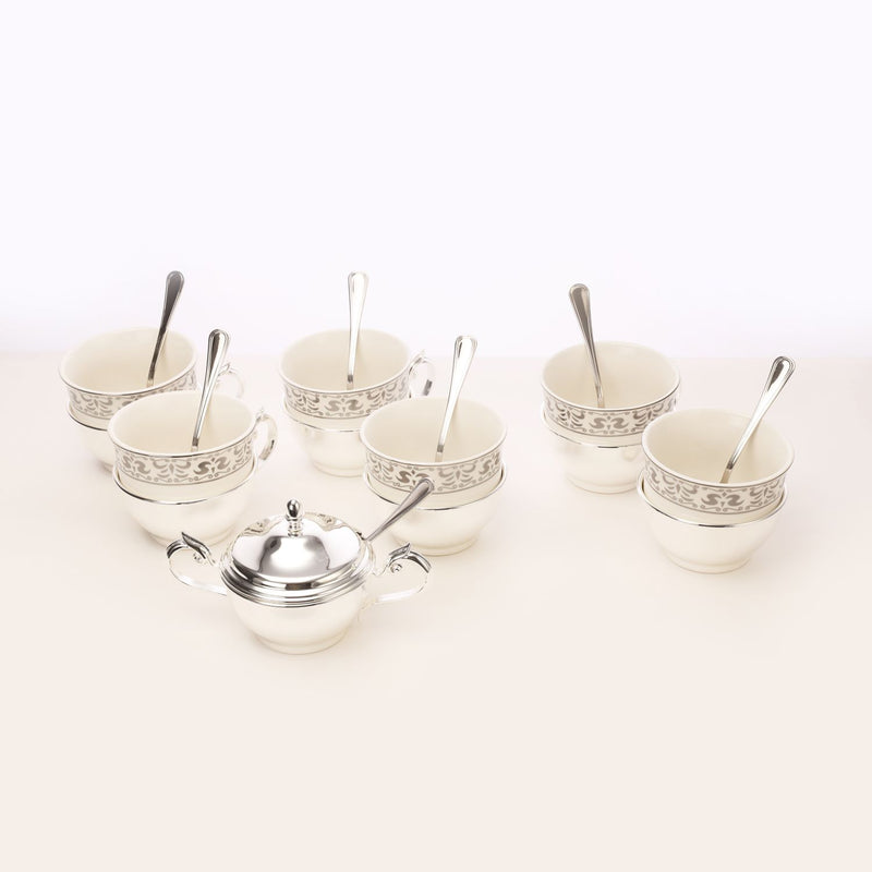 Silver tea cup with sugar pot and spoon