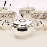 Silver tea cup with sugar pot and spoon