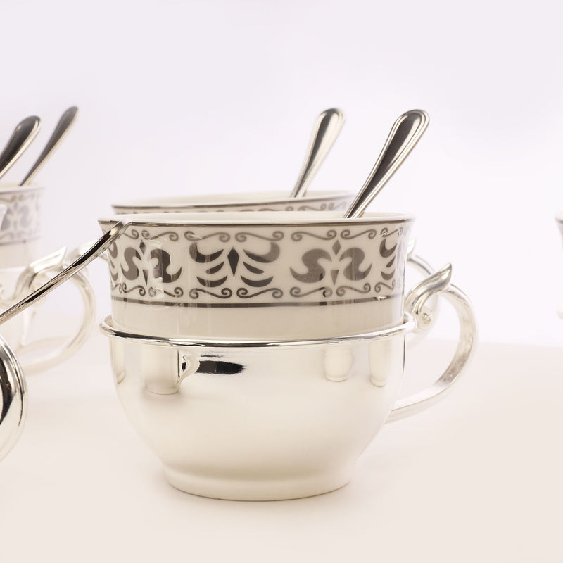 Silver tea cup with sugar pot and spoon