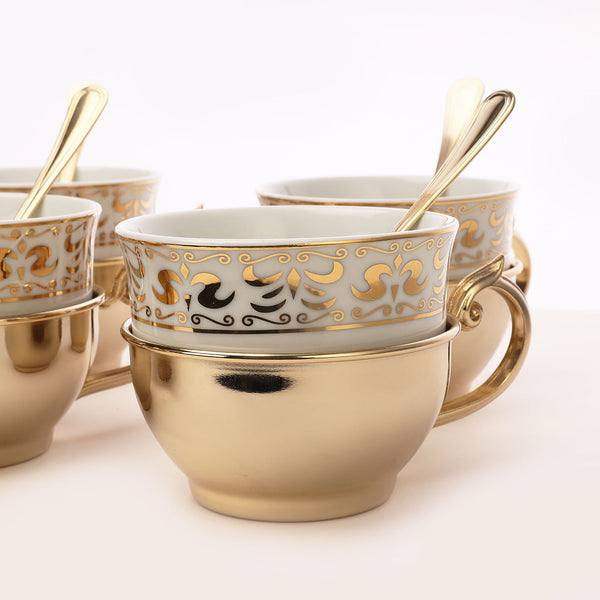 Golden tea cup with sugar pot and spoon